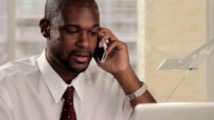stock-footage-business-man-talking-on-the-phone-in-his-office-close-up
